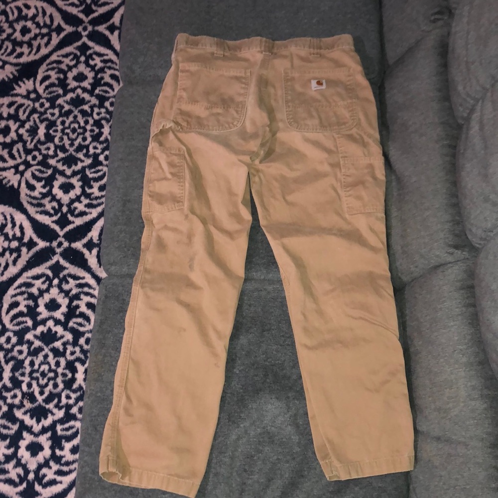 Carhartt tan Color pants 34x32 authentic and in good condition.